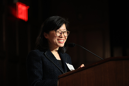Wenya Bi, MD, PhD, presenting at the symposium