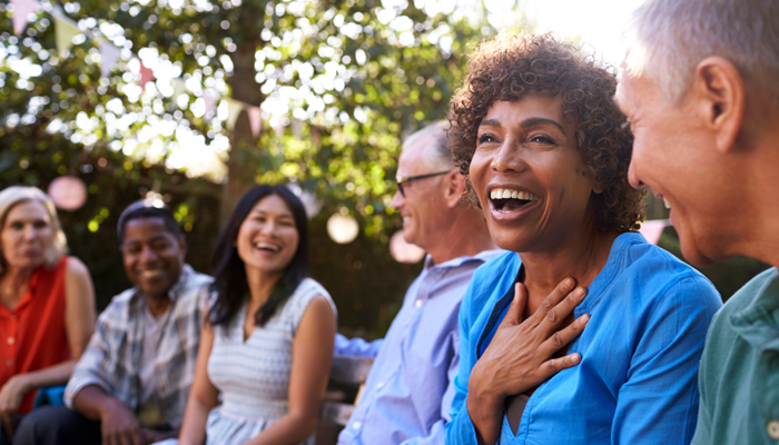 diverse group of people chatting in park