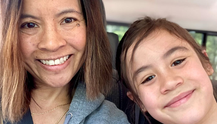 A patient smiling with her young daughter