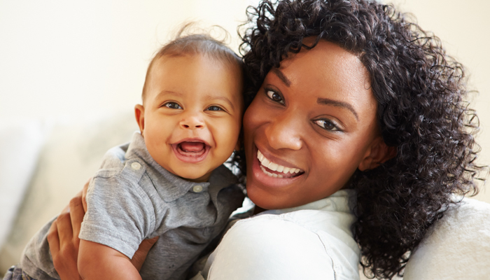 Young mother holding smiling baby