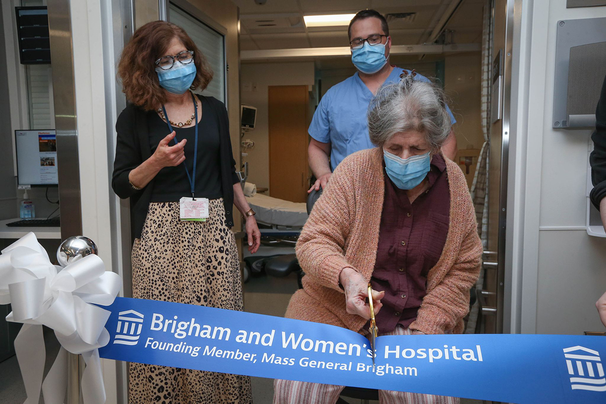Nan Winslow cutting ribbon at opening celebration