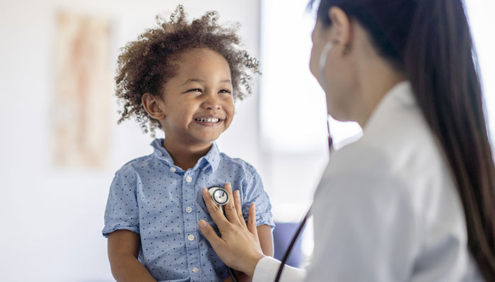 A pediatrician with a young patient
