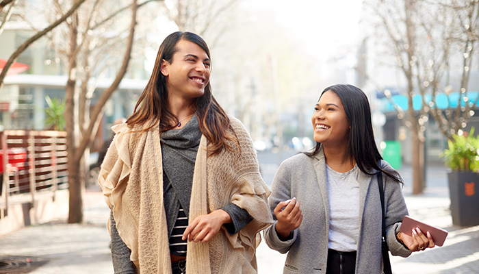 transgender woman walking along street with friend