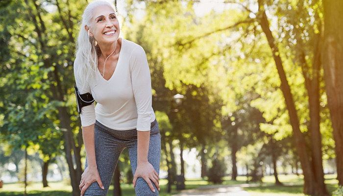 Woman stopping for rest while jogging