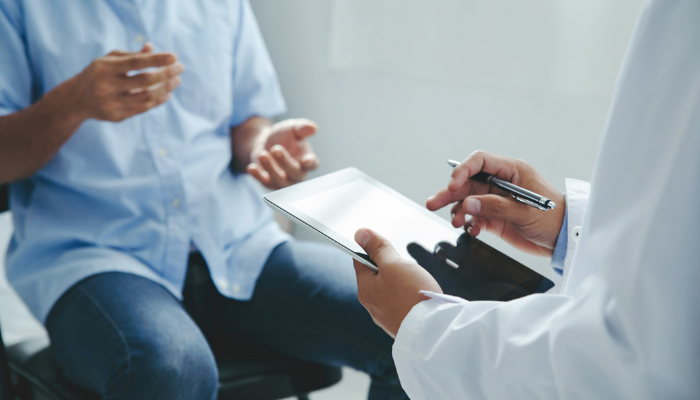 Researcher talking to patient
